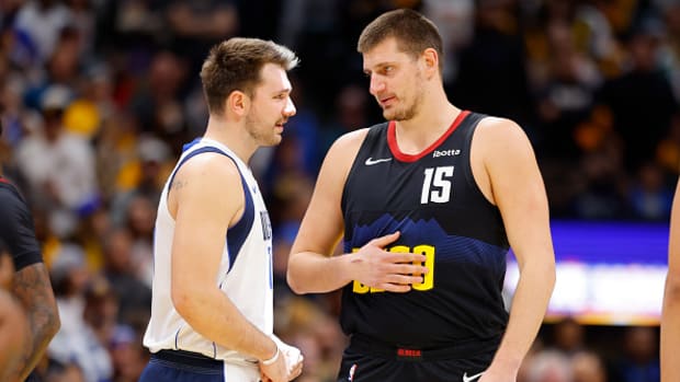 Luka Doncic talks to Nikola Jokic during the Dallas Mavericks’ game against the Denver Nuggets on Friday night.